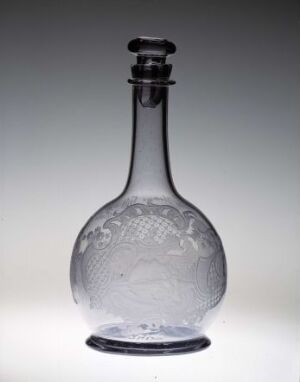  A transparent glass decanter with a bulbous base and slender neck, featuring an embossed floral design, displayed against a graduated neutral background with a glass stopper inserted into the neck.