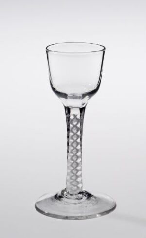  A clear stem glass with a diamond-cut pattern on the stem, set against a gradient grey to white background. Artistname and title are unknown.