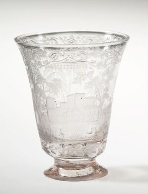  An intricately etched, transparent glass goblet with a wide brim, tapering to a narrow base, standing on a short stem with a sturdy foot, against a plain white background.