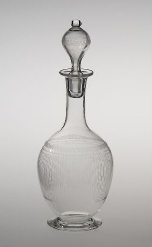  A clear glass decanter with etched design by Hadeland Glassverk. It has a bulbous body with tapered neck and matching stopper, displaying the fine etched details and the play of light through the translucent material.