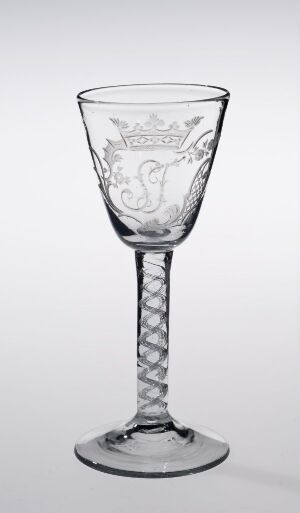  A clear glass goblet with an etched pattern on the bowl and a helical stem, set against a neutral background. Artist name and title are unknown.