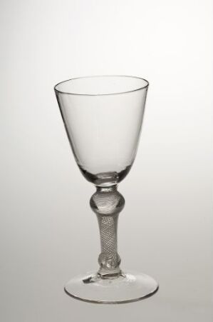  An elegant clear glass goblet with a bell-shaped bowl, ornamental spherical detail on the stem, and a flat circular base, against a light gradient background transitioning from white to light grey. Artist name and work title are unknown.