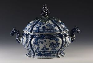  A traditional blue and white porcelain covered bowl with decorative floral patterns, featuring a domed lid with finial and stylized handles.