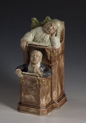  "The Vicar and Moses," an intricate piece of Kunstindustri featuring a vicar leaning tiredly on a pulpit above a figure of Moses, made from Flintgods material in sepia and brown tones, indicating a scene of narrative importance or religious context. The artist's name is unknown.