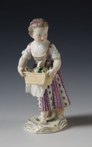  A porcelain figurine of a young woman in historical attire holding a basket, with a white and purple dress, pink headband, and standing on a base painted like grass.