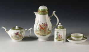  An elegant porcelain tea set against a light grey background. The set includes a teapot, coffee pot, sugar bowl with lid, and a cup with saucer, all in white adorned with hand-painted floral designs and green and gold accents.