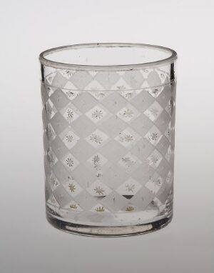  A clear glass with a diamond pattern decoration stands against a light-grey background, reflecting light and emphasizing its empty, transparent quality. Artist name and title are unknown.