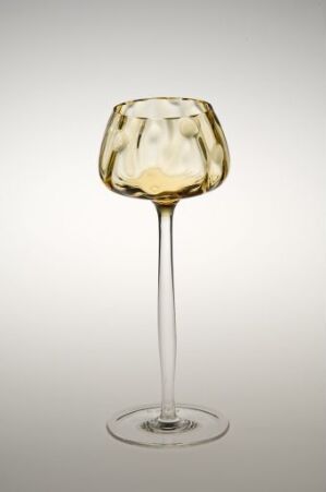 ** A unique wine glass with a distorted, crumpled bowl with a subtle gradient from clear to golden hue on a near-white background.