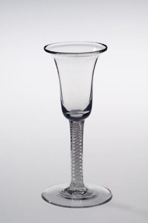  An elegant clear glass goblet with a flared rim, a helical pattern within the stem, and a flat circular base against a light gray-to-white gradient background.