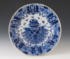  A blue and white porcelain plate with a deep cobalt blue decorative pattern of stylized floral motifs and scrolls on a white background. The design features a centered intricate figure surrounded by concentric circles of detailed ornamentation, with a patterned border along the rim.