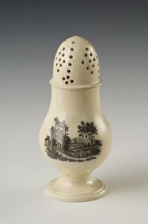 
 A porcelain egg-shaped object with a base and a perforated top, featuring a monochromatic landscape scene with classical architecture in shades of grey.