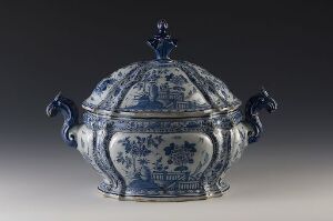  A traditional blue and white porcelain tureen with cobalt blue handles and finial, featuring detailed blue artwork on a white background.