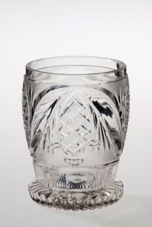  A clear cut-glass with decorative patterns featuring diamond shapes and leaf-like designs. The glass has a smooth rim, a textured body, and a base with rounded nodules, all reflecting light to enhance its intricate details.