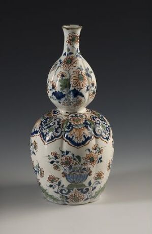  An antique double-gourd-shaped vase with detailed blue and accentuated orange patterns on a white background, suggesting traditional craftsmanship with no known artist or title.