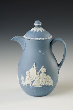  A traditional ceramic coffee pot in matte blue with an intricate white floral motif wrapping around its lower half and a decorative knob on the lid.