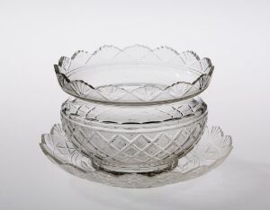  Two clear cut-glass bowls with diamond patterns on the bottom and scalloped edges, displayed against a light grey background.