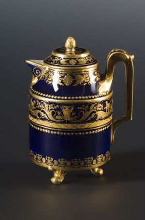  An elegant teapot with a cobalt blue body and golden embellishments, featuring intricate scrollwork, florals, and geometric patterns, with a reflective golden handle and decorative lid against a dark background. Artist name and title are unknown.