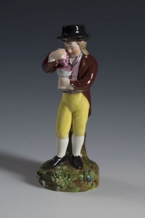  A porcelain figurine titled "Høsten" by Den kgl. Porcelainsfabrik, depicting a male character in traditional, autumnal attire. He stands on a textured base resembling an autumn ground, wearing a black tricorn hat, a magenta jacket over a white ruffled shirt, mustard yellow breeches, and black shoes. The piece exhibits rich colors and a proud stance, capturing the essence of the harvest season.