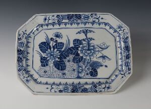  An octagonal blue and white porcelain serving platter featuring intricate floral and geometric patterns, suggestive of traditional Chinese or Delftware styles, with no identifying artist or title.