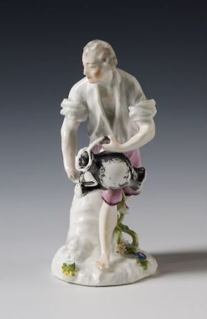  A porcelain figurine of an 18th-century woman standing with