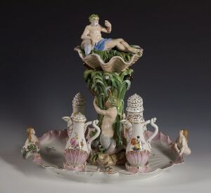  "Havguden Neptun og hans følge" by Den kgl. Porcelainsfabrik, is a porcelain sculpture featuring Neptune atop a spiraled sea column, surrounded by sea nymphs and marine life, all rendered in delicate pastel colors and glazed to perfection, evoking a mythological underwater scene.