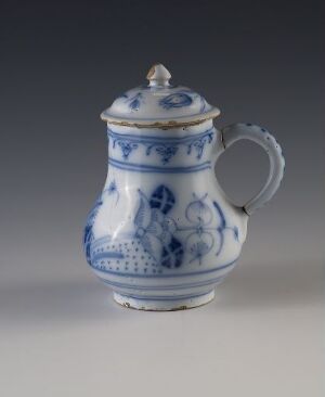  A blue and white porcelain teapot with intricate patterns, featuring a curved spout, a looped handle with leaf-like embellishments, and a rounded lid with a decorative knob, set against a neutral grey background.