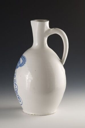  A white ceramic pitcher with a subtle blue decorative pattern around the neck, featuring an elegant handle and a smooth, classic design.