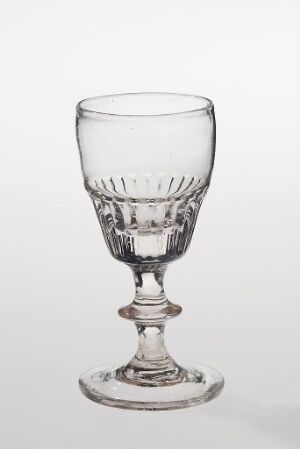  An elegant, empty clear glass goblet with diamond-cut details on the upper bowl, a detailed stem, and a sturdy base, displayed against a pure white background.