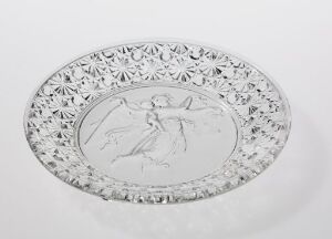  An oval clear glass plate with embossed classical dancer design in the center and intricate cut-glass patterns around the edges on a white background.