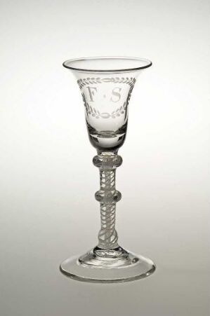  A clear glass goblet with a decorative stem and detailed etching on the rim, set against a gradient gray background. Artist name and title are unknown.