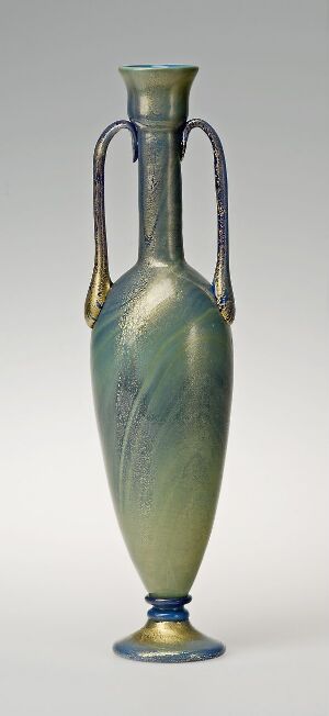  A slender, elongated vase with a seafoam green and pale blue iridescent finish, mottled with shades of yellow-green. It features twin metallic bronze-toned handles and a cobalt blue foot, set against a neutral background. Artist name and title unknown.