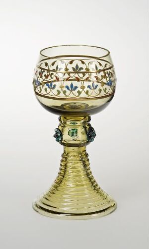  A decorative goblet with a patterned, enamel painted transparent bowl and gilded metallic stem and base, set against a neutral background.