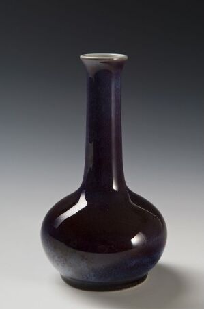  A tall, slender-necked vase with a bulbous base, rendered in a rich, dark purple color with a glossy finish, set against a gradient gray background. Artist name and title are unknown.