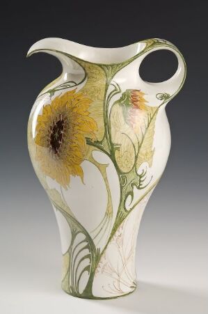  An ornate vase with a creamy background adorned with painted golden-yellow sunflowers with brown centers, and green stems and leaves, creating an Art Nouveau style.