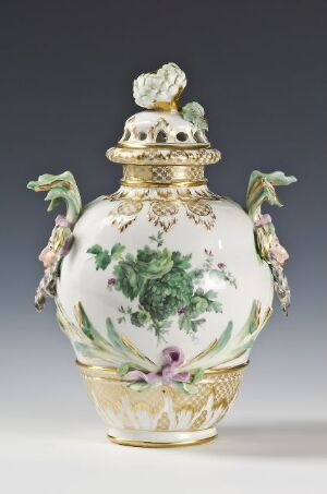  An ornate porcelain vase with lid, featuring a white background, decorated with detailed green leaves, purple and pink flowers, and gold accents on the handles, base, rim, and lid finial. Artist name and title remain unknown.