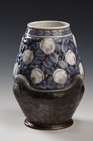  A ceramic vase with a blue and grey floral design, featuring a bulbous body, tapered neck, and a small, stable base.