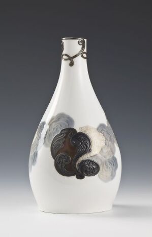  A tall white art bottle with a long neck and a small loop just below the lip, adorned with abstract dark gray and black cloud-like patterns, set against a neutral gray background.