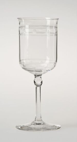  A clear glass goblet with a cylindrical bowl, slender stem with a central knop, and flat base, displayed against a light gray background.