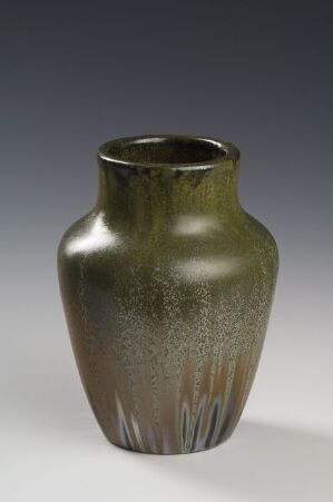  A ceramic or glass vase with a dark olive green to smoky gray gradient, showcasing a tapered form with a narrow neck and slightly flared rim, set against a gray background.