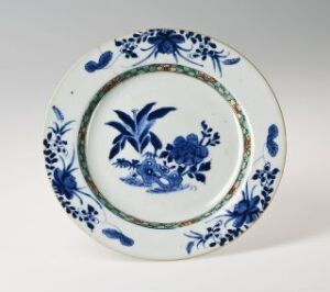  A white porcelain plate with blue floral motifs and patterns, showcasing traditional blue and white ceramic design.