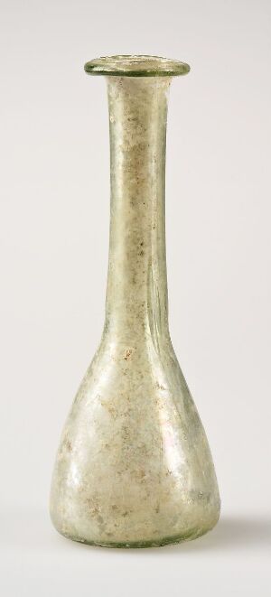  An ancient-looking, slender glass vase with a narrow fluted neck and wider base, displaying a muted silvery-gold sheen against a light gray background.