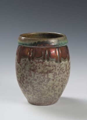  Small ceramic pot with a glossy glaze, featuring a dark green rim that transitions into a brown band above a speckled gray and white body, against a neutral gray background.