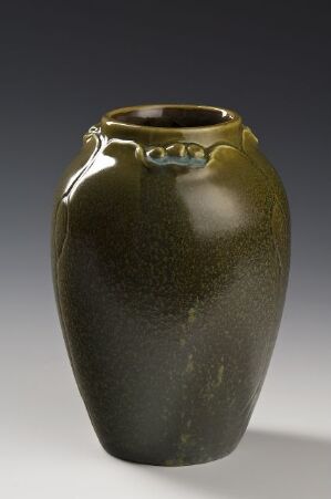  A green ceramic vase with a bulbous body, short neck, and two small twisted handles near the lip, displayed against a gray background. The vase features a mossy green glaze with darker streaks and olive green highlights.