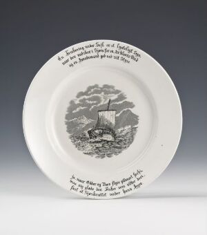  A round white ceramic plate with a grayscale illustration of a sailing ship at sea in the center and encircling inscription on the plate's rim.