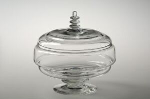  A clear glass candy dish with a ridged design and a twisted finial on the lid, displayed against a light grey background.