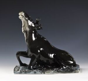  A glossy black feldspar porcelain figurine titled "Modell 1956" by Johan Sirnes, depicting a rearing horse or mythical creature with detailed stylized mane and expressive posture, set on a textured base resembling rocky ground.