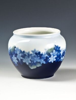  A Feldspar porcelain vessel by artist Fru Rose Martin with a bulbous form, featuring a deep blue base that transitions to white with a pattern of stylistic blue flowers around it.