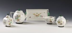  A Thor B. Kielland-designed feldspar porcelain tableware set, featuring a teapot, sugar bowl, creamer, and a rectangular serving tray adorned with delicate floral overglaze decoration, primarily in soft pastels against a pure white background.