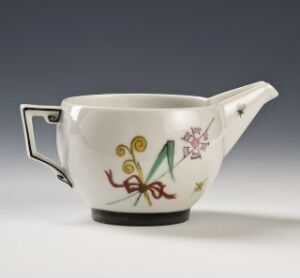  A white feldspar porcelain sauce boat by Thor B. Kielland, featuring an elegant design with a long spout and sharp handle, decorated with a green and brown abstract geometric shape and pink floral accents on a soft grey background.