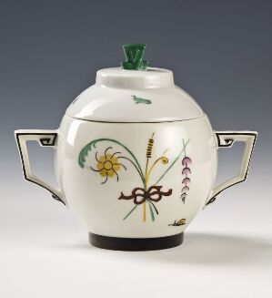  A white hexagonal porcelain teapot from Modell 1830 by Porsgrunds Porselænsfabrik AS with emerald green lid knob, black and gold-trimmed handles, and colorful overglaze botanical decorations in yellow, green, lavender, and reddish-purple.